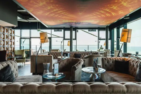 A room with sofas and coffee tables.