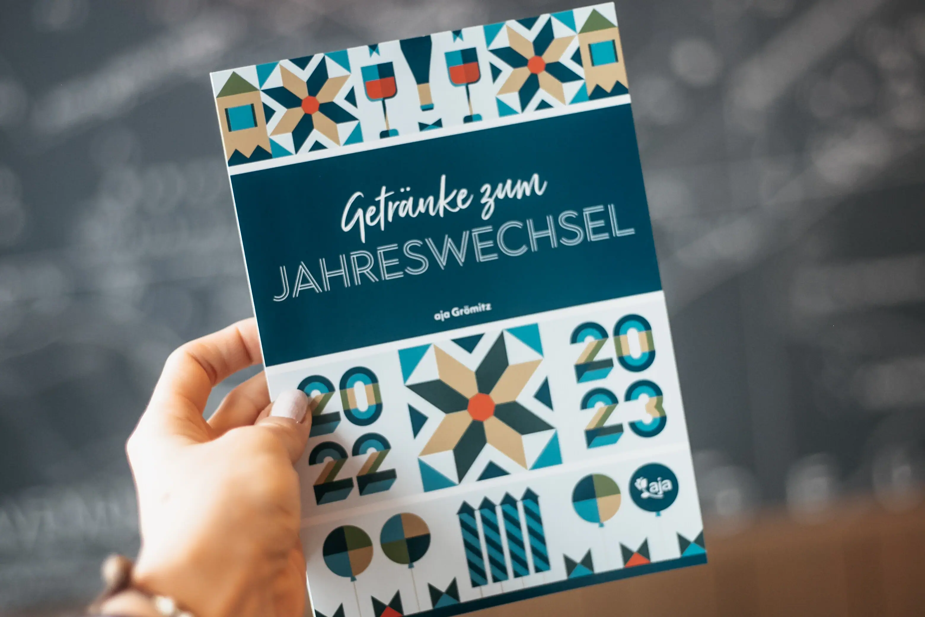 New Year's Eve at aja Warnemünde Hand holds a programme booklet with handwritten notes.