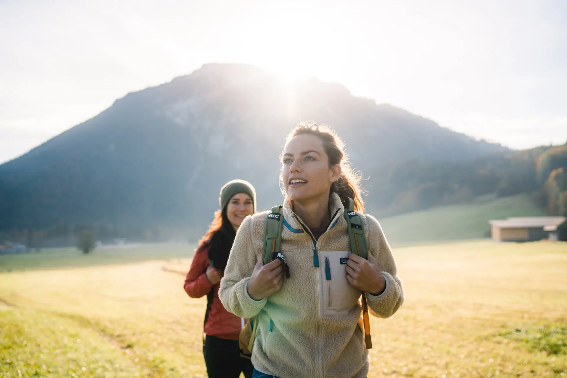 A group of women walking in a field.