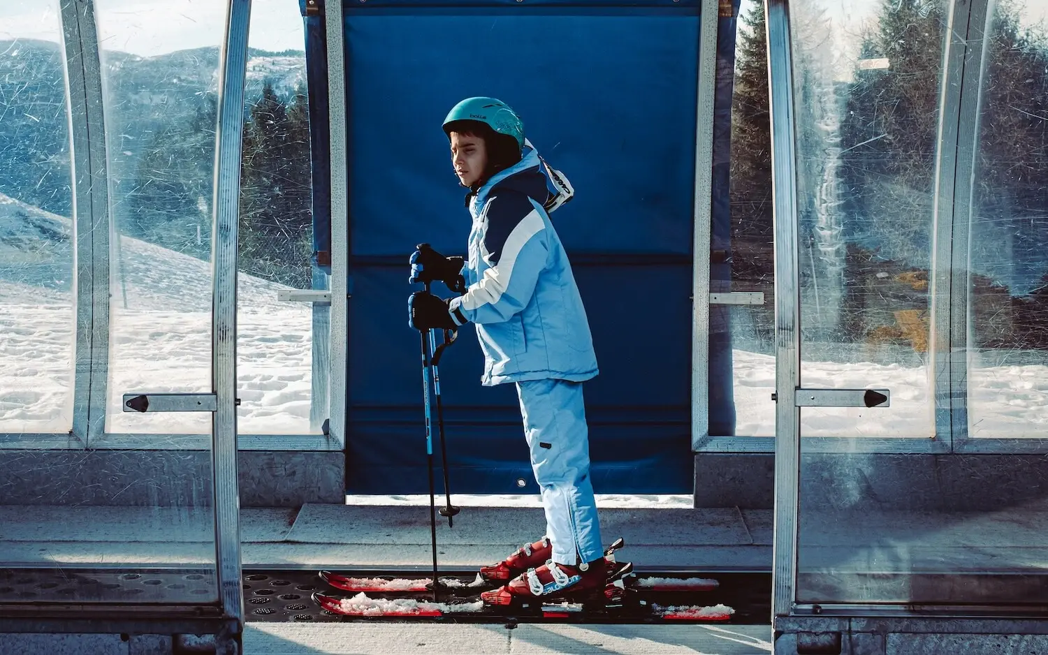 Child on skis outdoors, wearing winter clothing.