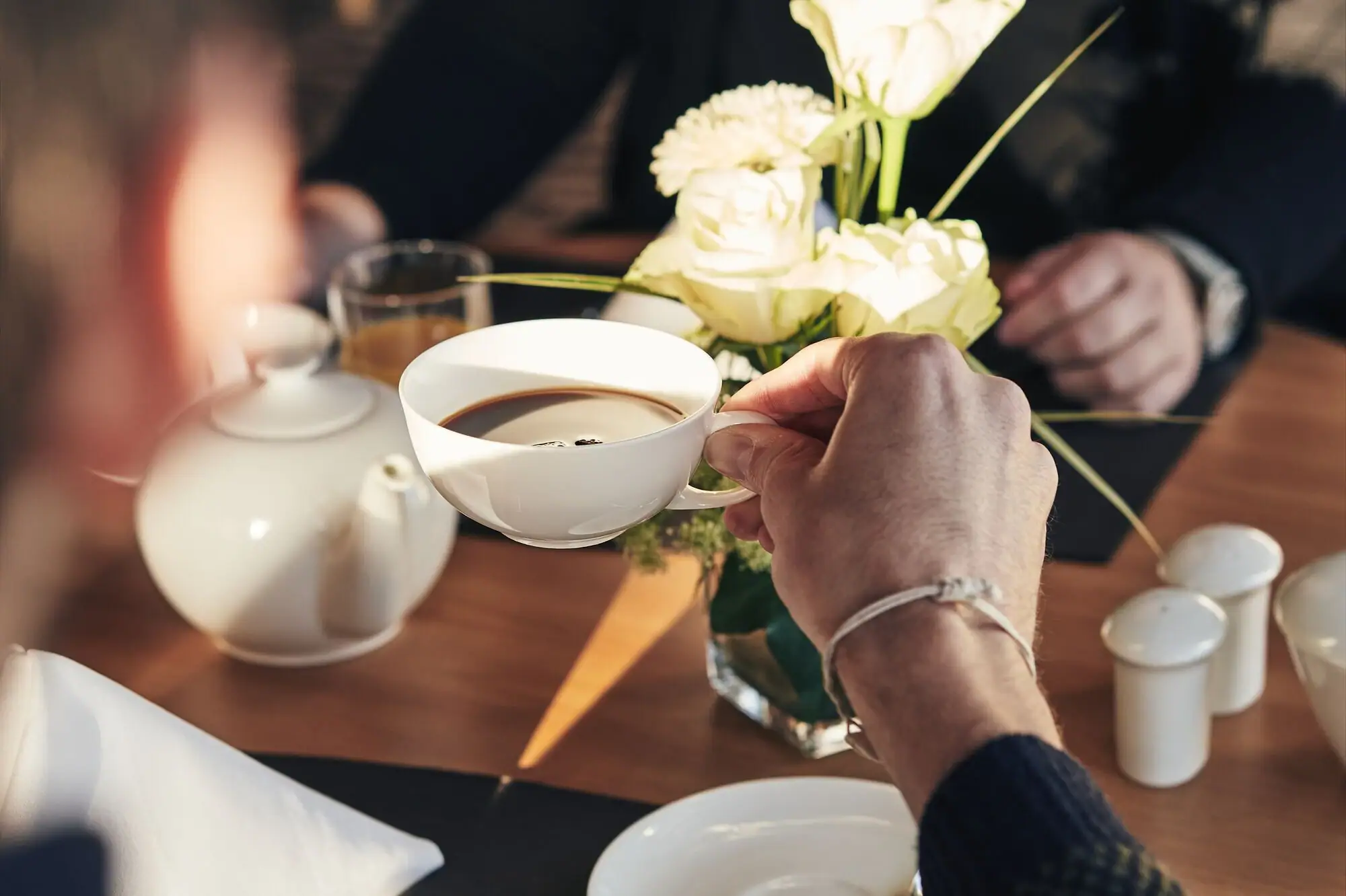 Coffee A person is holding a cup of coffee.
