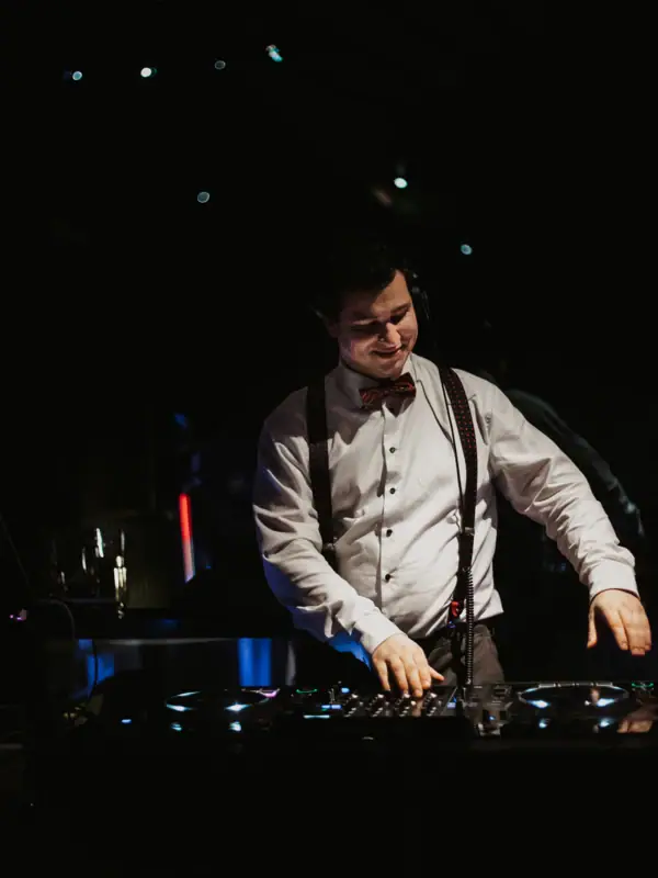 A man wearing a bow tie and headphones.