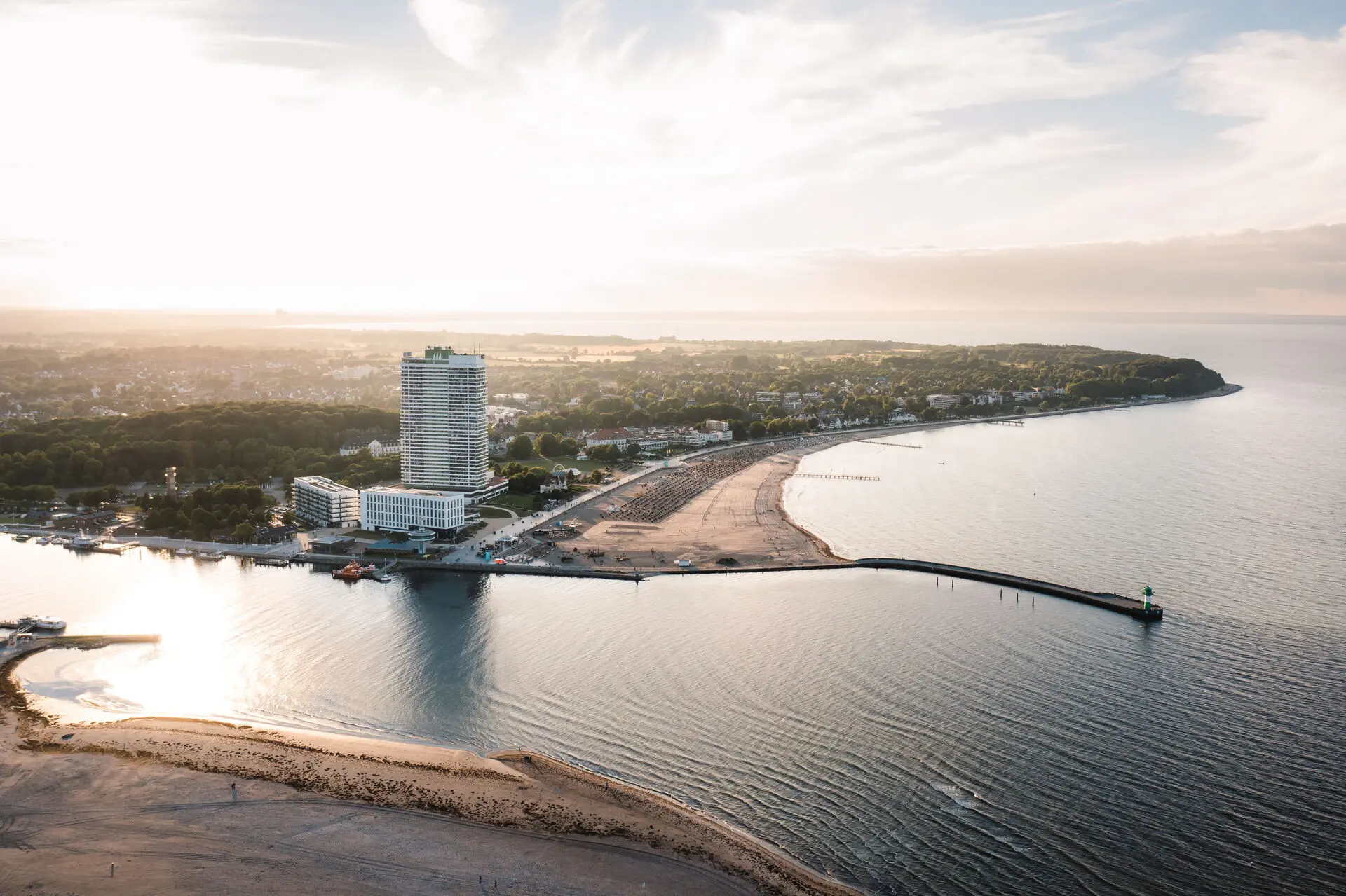 Beach landscape with water and a tall building in the background