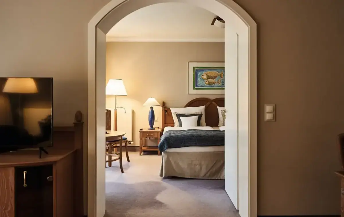 Bedroom with bed, bedside table and lamp.