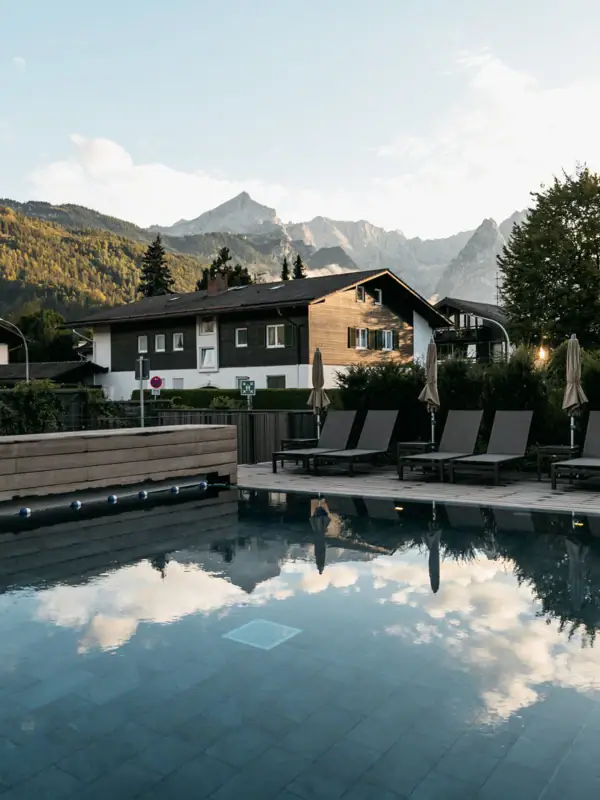 Outdoor pool A pool with chairs and a building in the background.