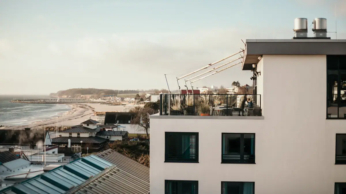 A building with a balcony overlooking a body of water.