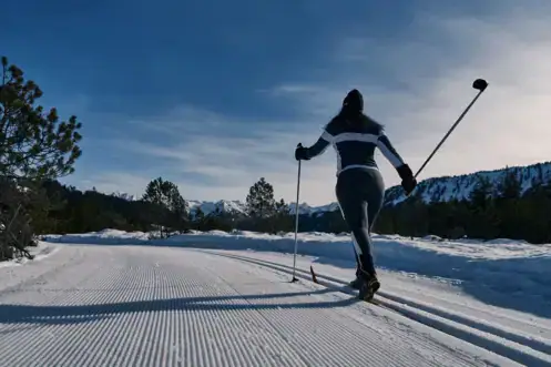 Cross-country skiing at Lake Achensee A person on skis on a snow-covered road.