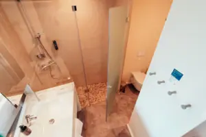 Bathroom with glass-door shower and washbasin