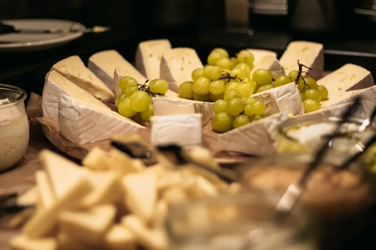 Cheese A plate of cheese and grapes.
