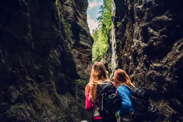 Two women are standing in a ravine.