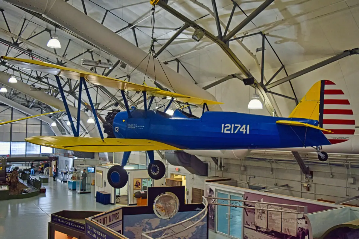 A blue and yellow aeroplane hanging from the ceiling.