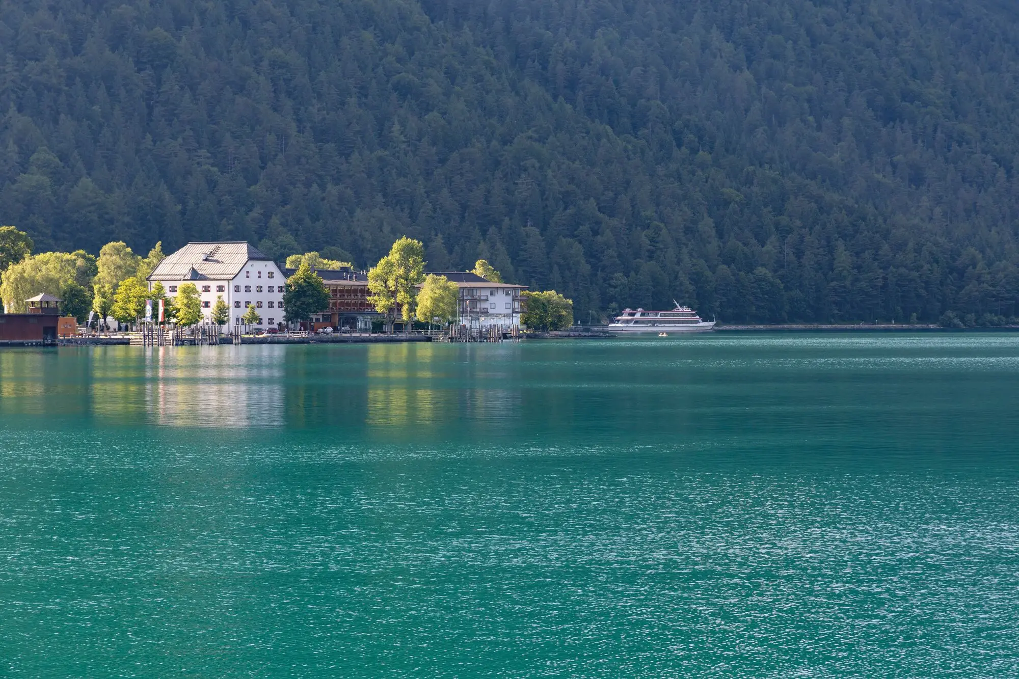 View of a lake with surrounding buildings and trees.