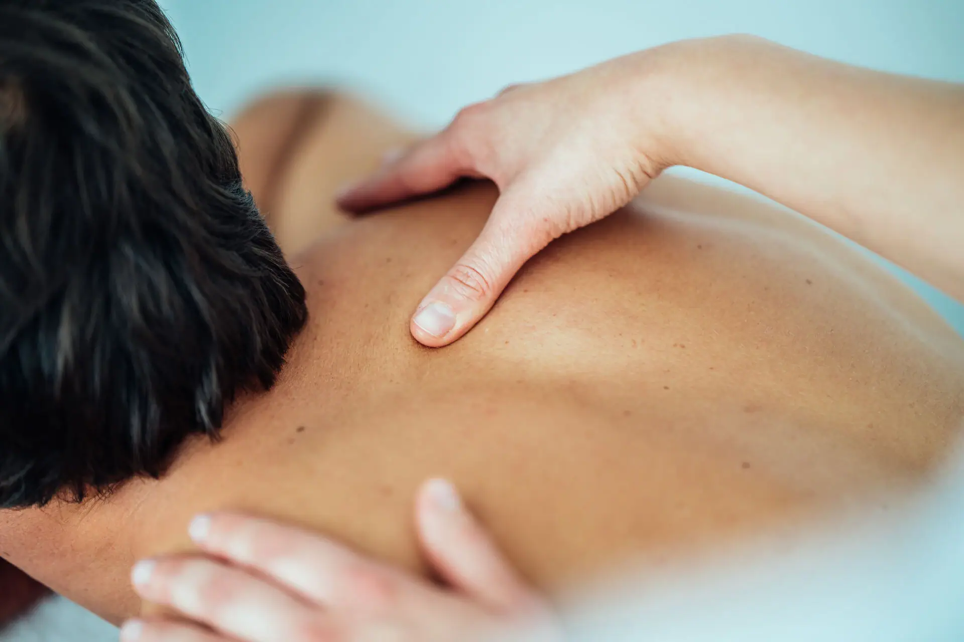 One person receives a back massage.