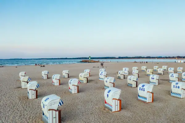 There are many beach chairs on the sandy beach of Travemünde.