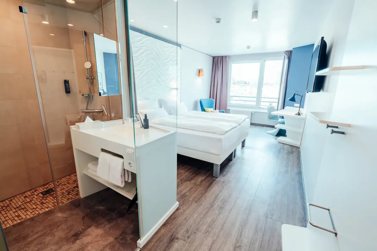 A room with two beds and a shower.