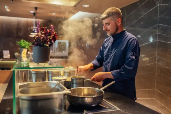 A man is cooking in a kitchen.
