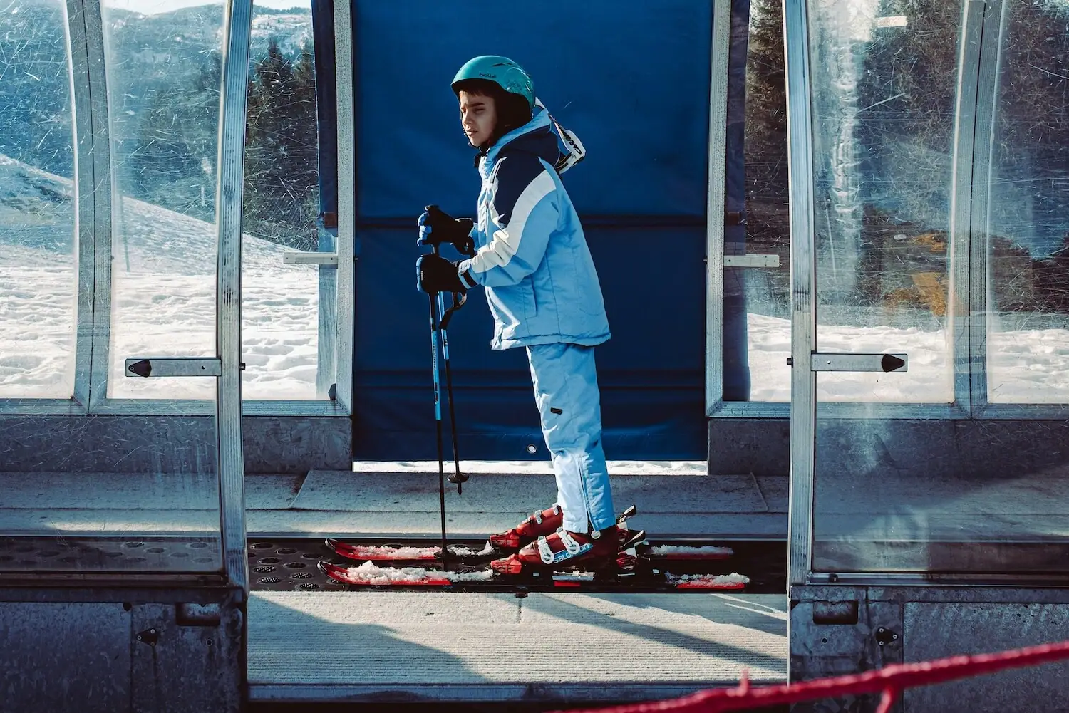 Child on skis outdoors, wearing winter clothing.