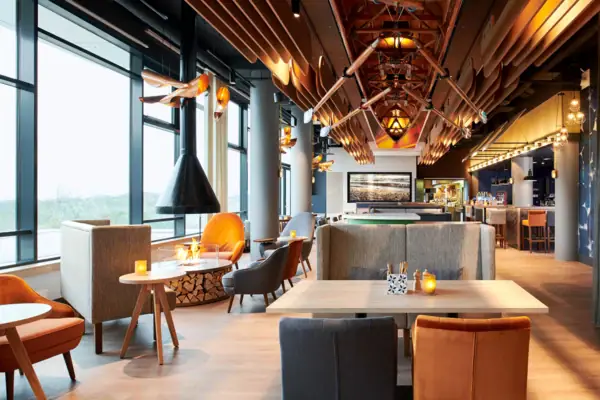 A restaurant with tables and chairs, modern furnishings.