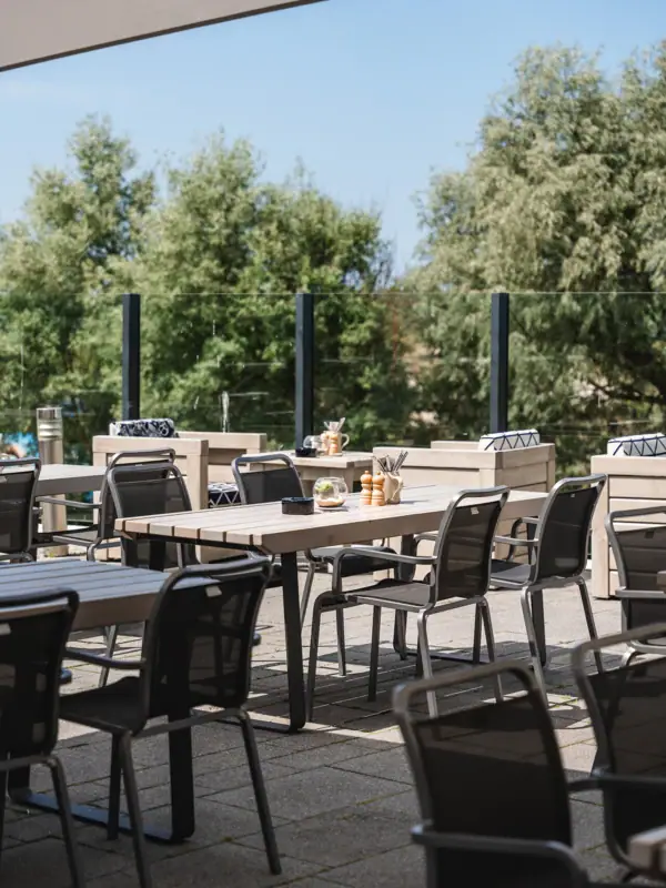 A table and chairs on a terrace.