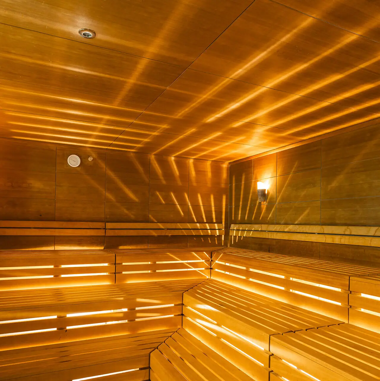 Sauna at aja Bad Saarow Wooden sauna with light shining through the walls.