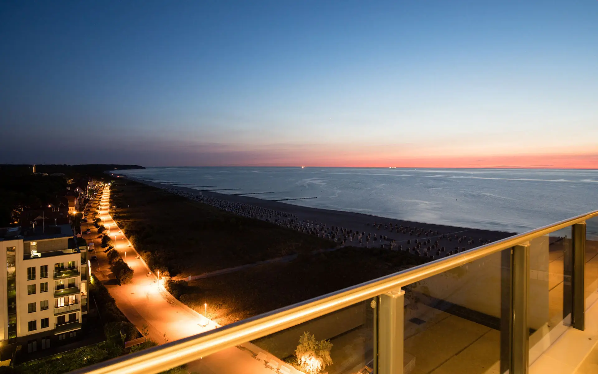 Aerial view of a stretch of beach at sunset over the sea