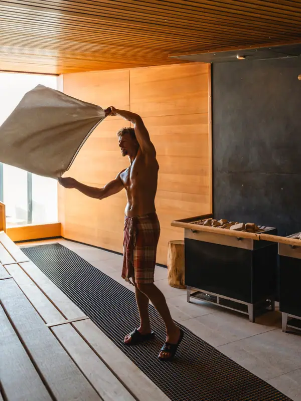 A man holds a towel in a room.