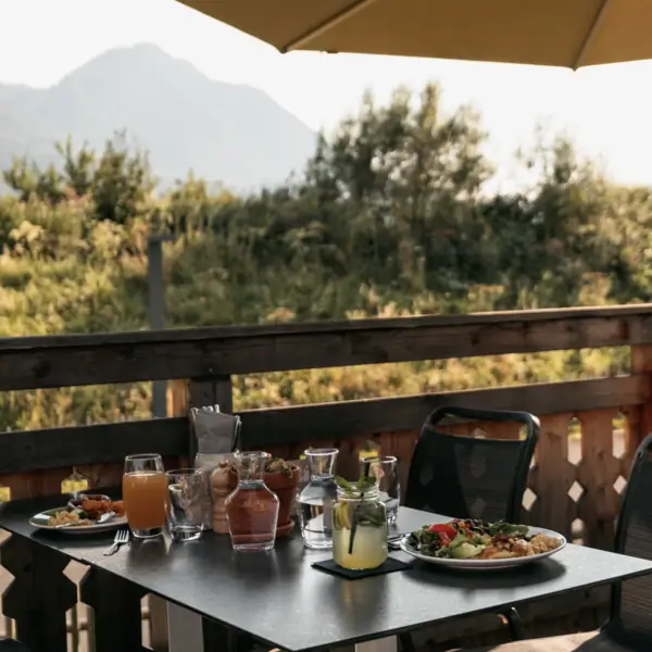 A terrace at the aja Family Hotel in Bavaria with a view of the mountains.