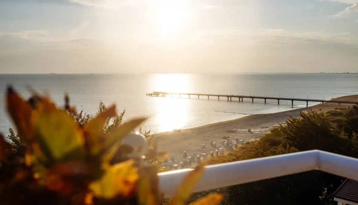 A beach with a jetty and a stretch of water.