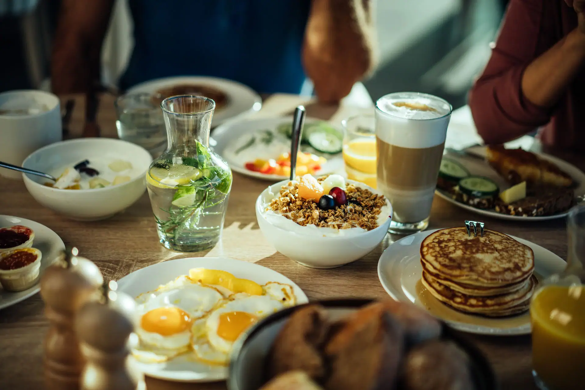 Breakfast A table with plates full of food and drinks.