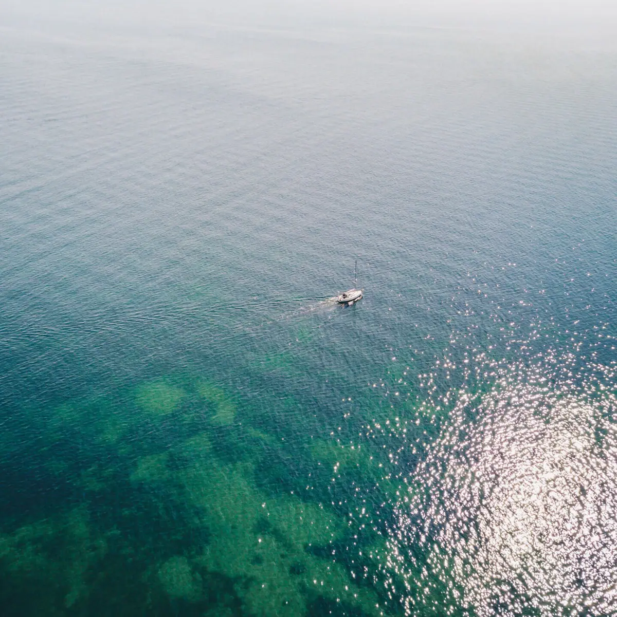 A boat in the water on a misty lake.