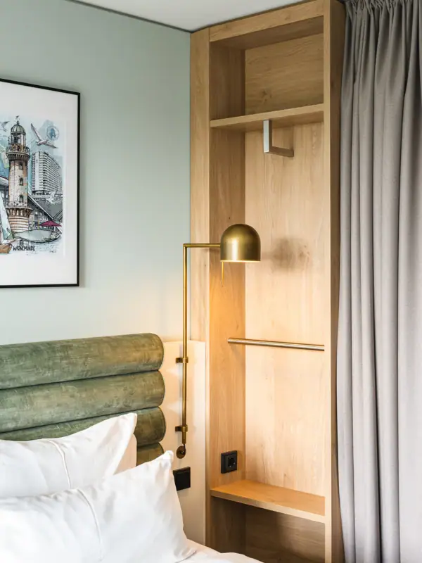 Bed with lamp and shelf in one room