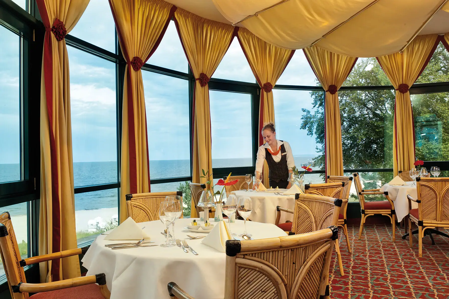 A woman serves a table in a restaurant.