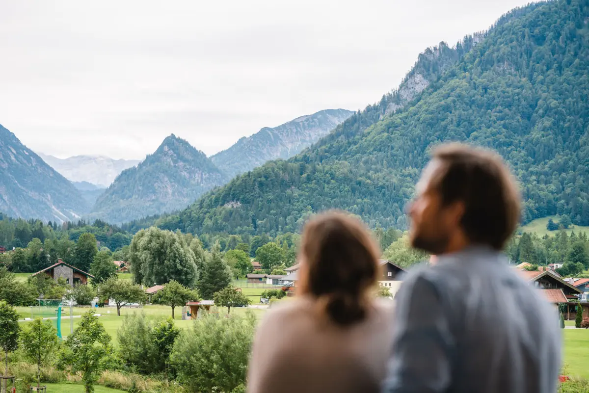 View from the balcony aja Ruhpolding A man and a woman look at mountains.