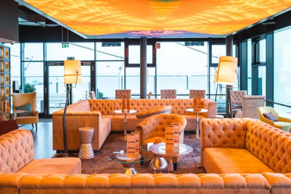 Ein Raum mit Sofas und Tischen.