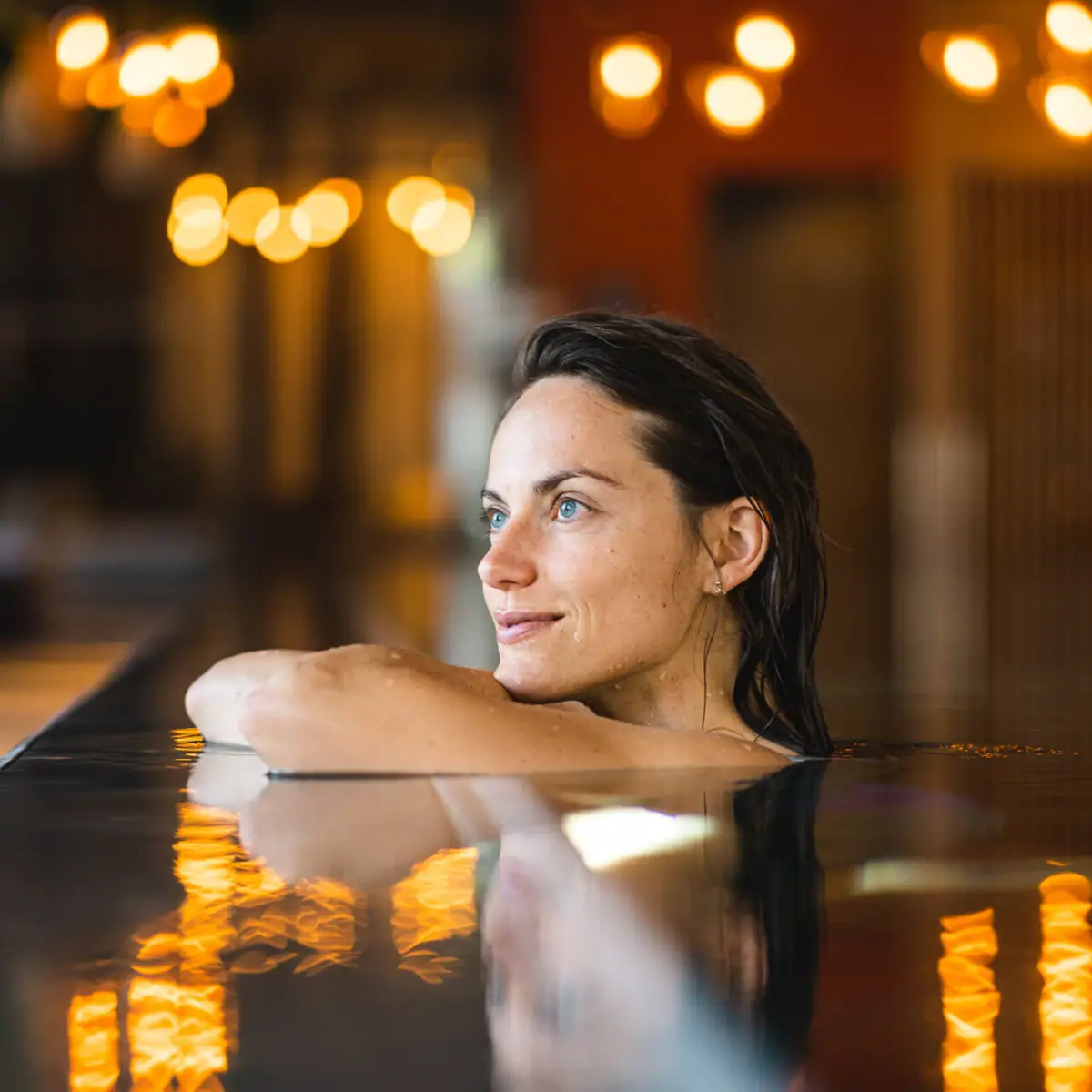 Indoor pool A woman in a pool at night by candlelight.