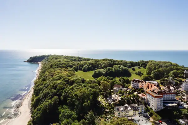 North horse Landscape with trees and buildings on the coastal strip, blue sky in the background.