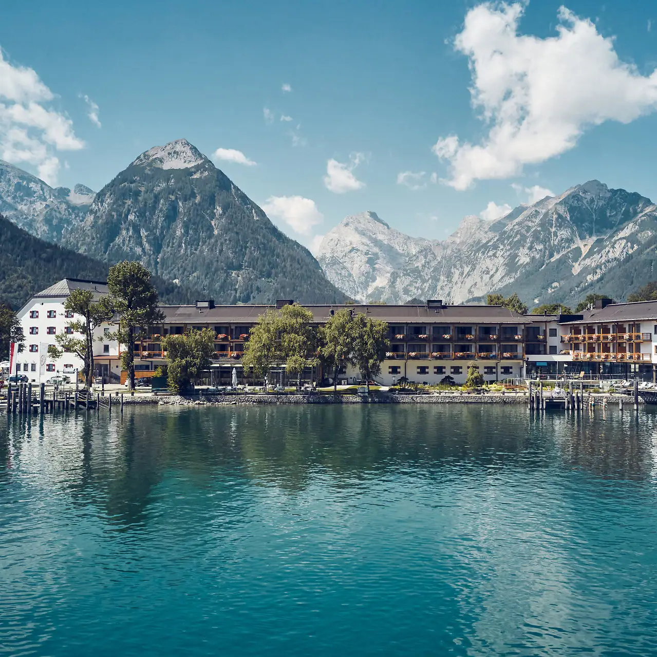 A building next to a body of water with mountains in the background.
