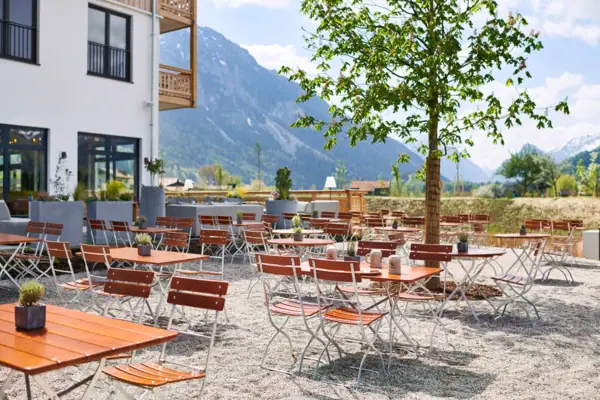 Beer garden aja Ruhpolding A group of tables and chairs outside in front of the aja Ruhpolding.