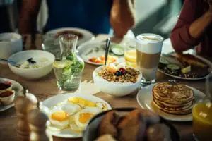 A table with plates full of food and drinks.