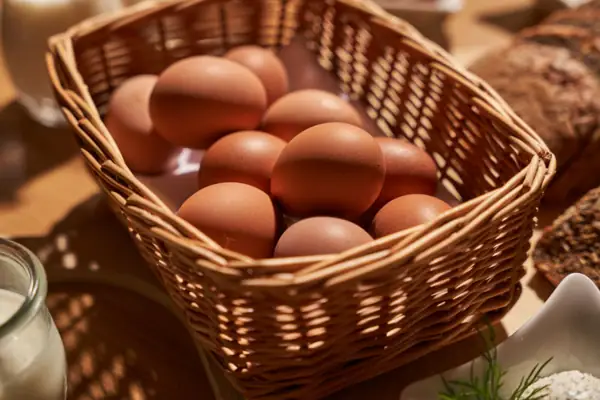 A basket full of eggs on a breakfast buffet.