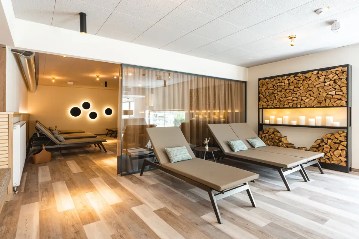 Relaxation room A room with lounge chairs and wooden shelves.