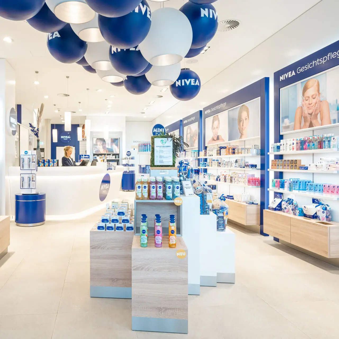NIVEA Shop A shop with blue and white balloons on the ceiling.