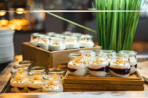 A table with desserts served in glasses.