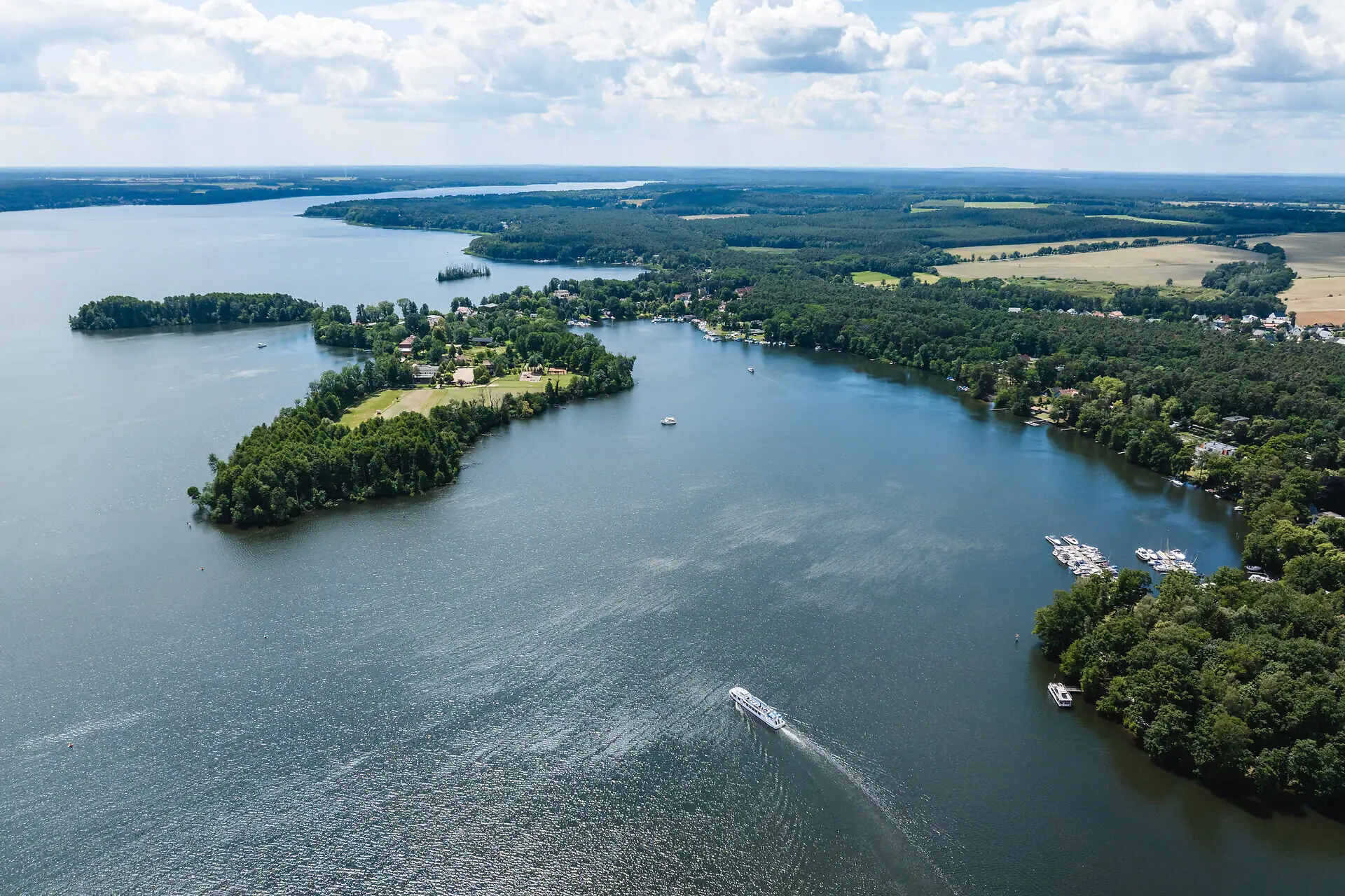 Scharmützelsee from the air Large water area with islands and boats.