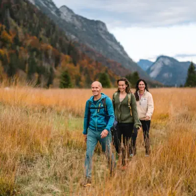 A group of people walking in a field.
