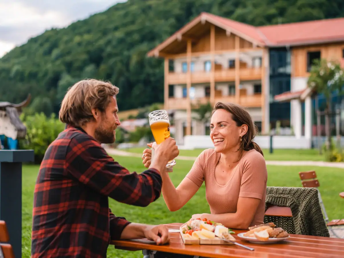 A man and a woman are sitting at a table with food and drinks.