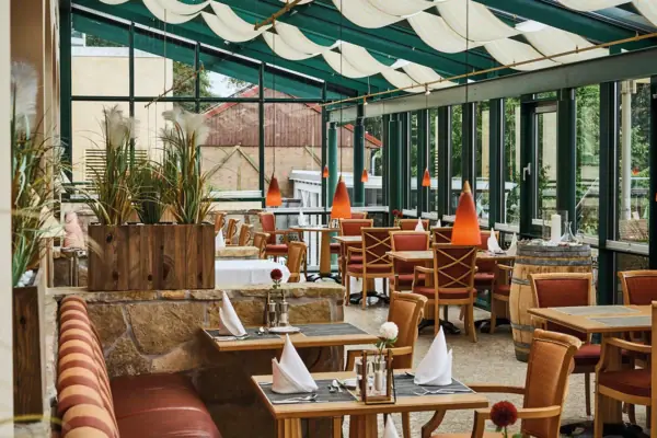 A restaurant with tables and chairs.