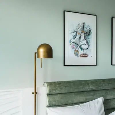 New rooms at aja Warnemünde Lamp next to a bed in the interior.