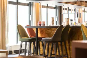 A room with a bar and chairs.