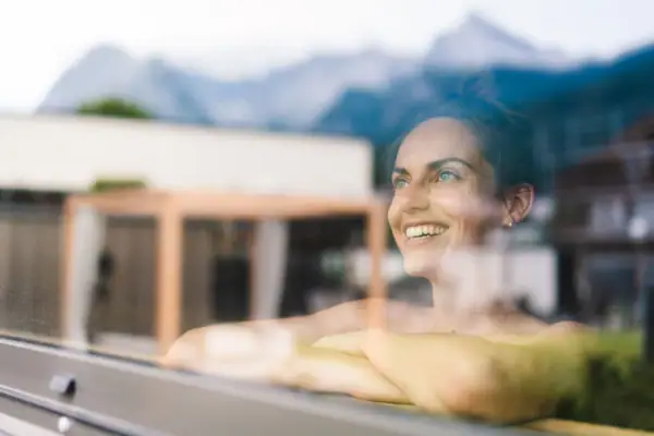Finnish sauna A woman looks out of a window.